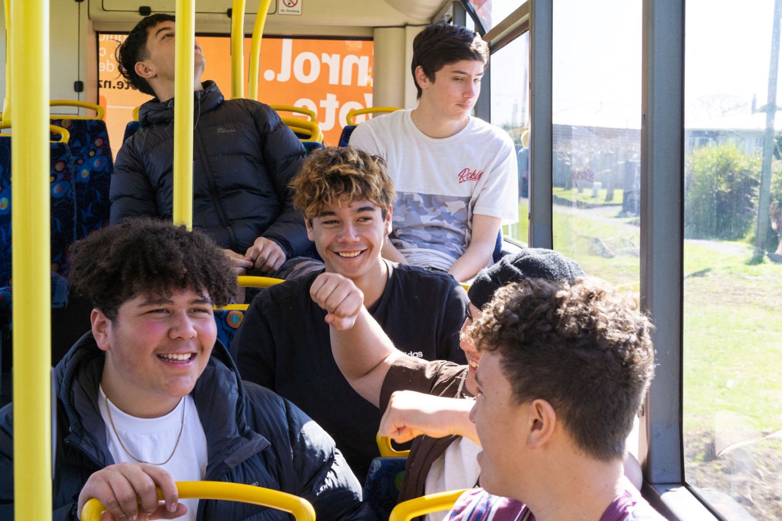 Young men smiling on the bus