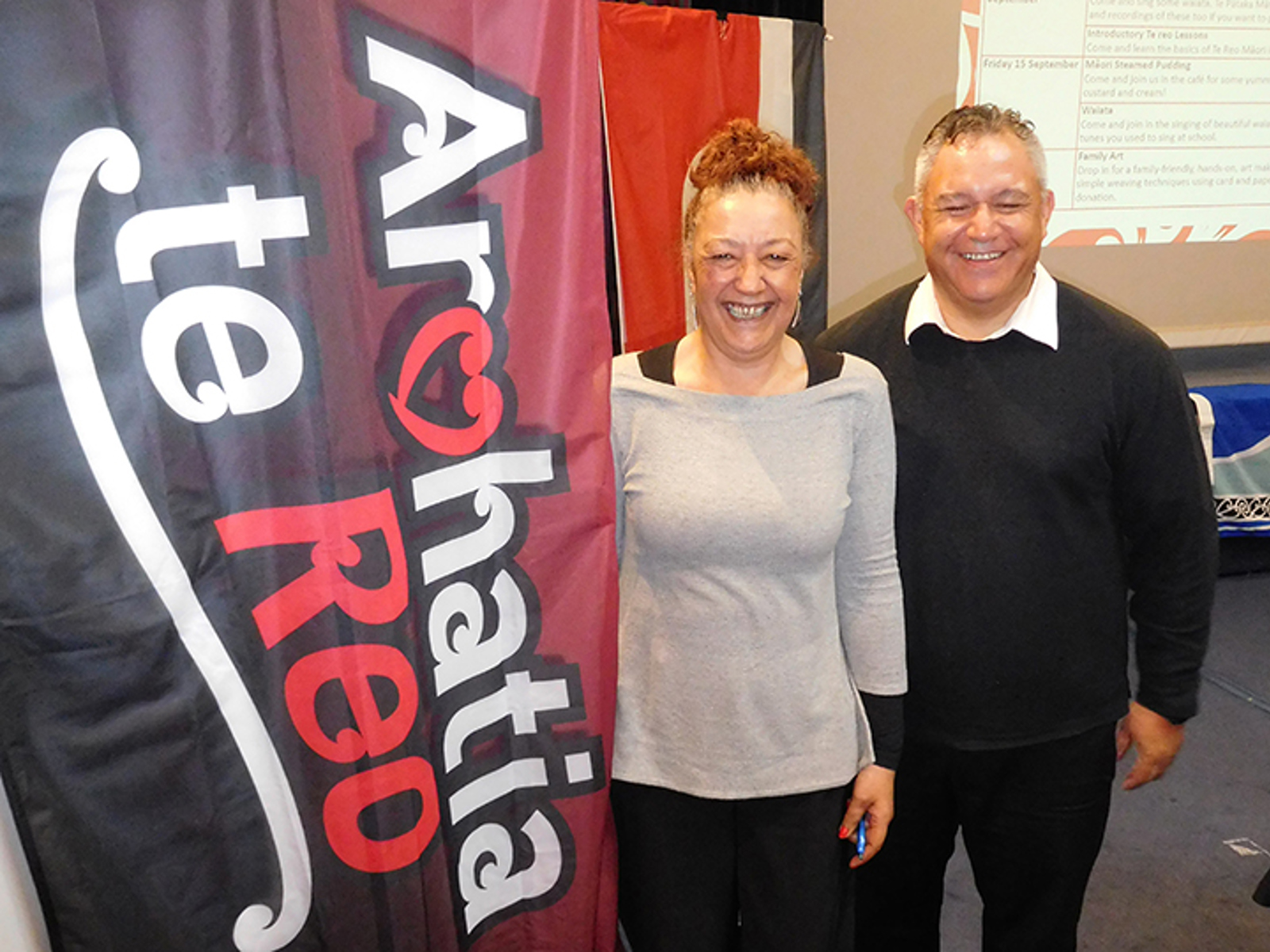 Aroha Chamberlain and Anaru Wilkie with Arohatia te reo sign
