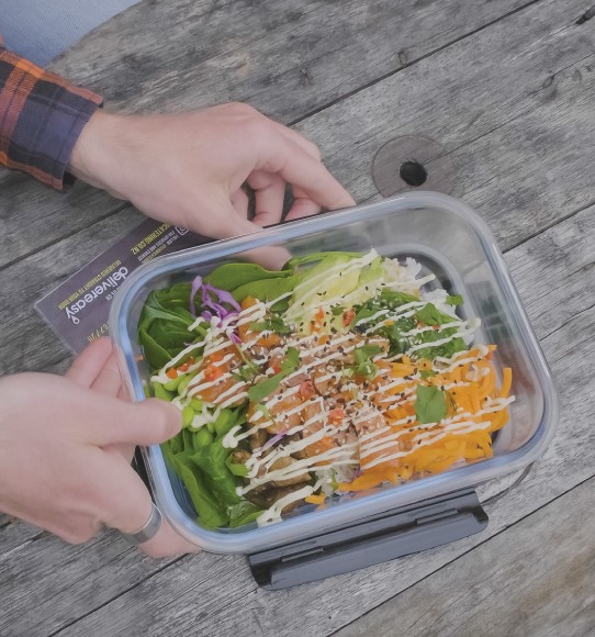 Person with food in reusable container