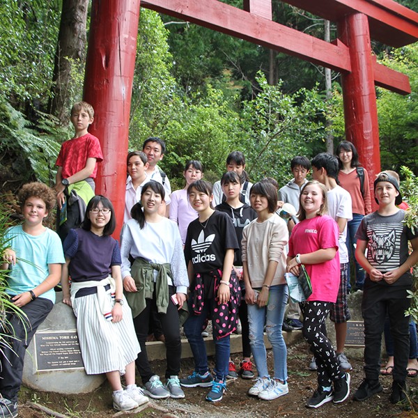 Group of exchange students standing in front of the Mishima Torii Gate
