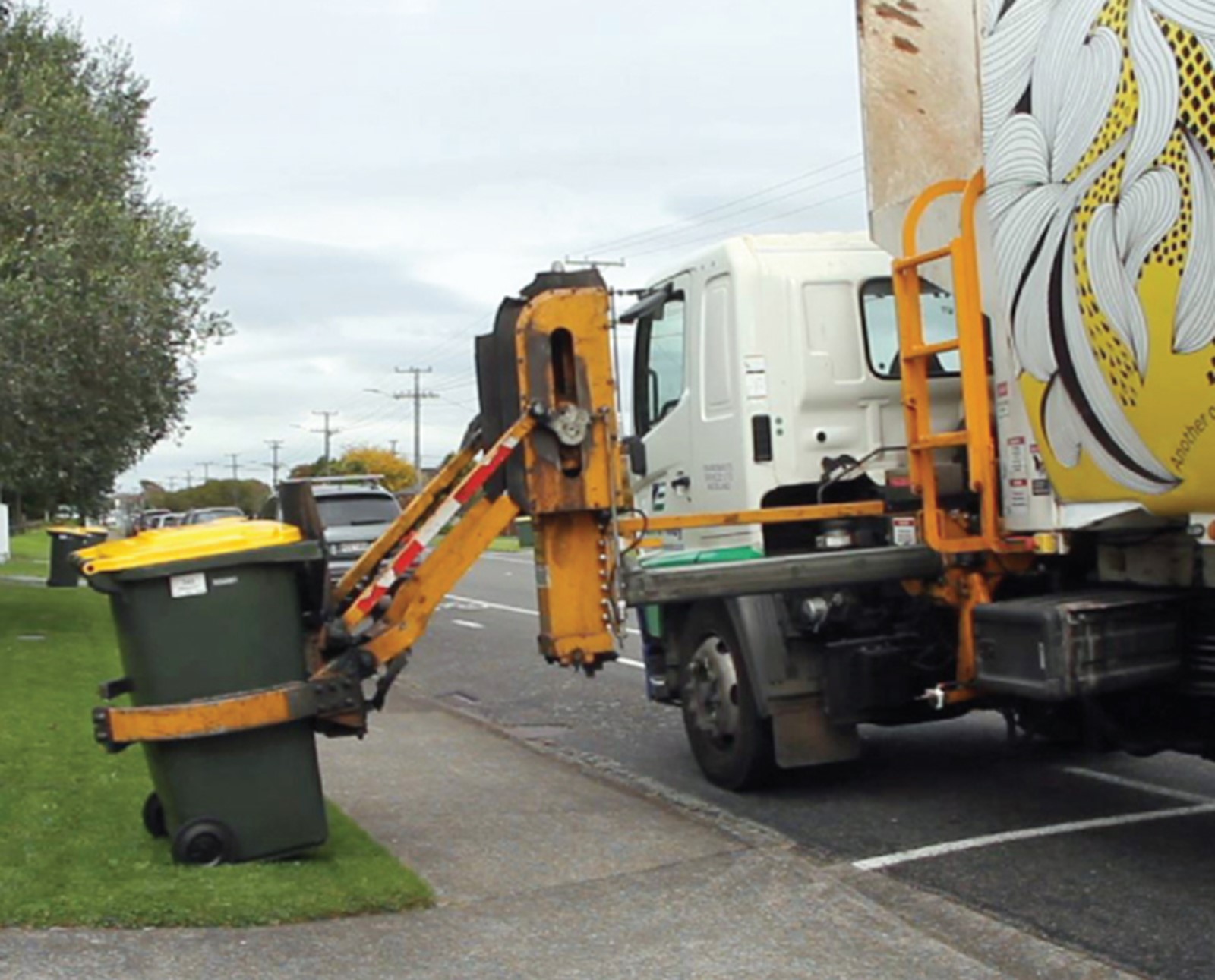 Rubbish truck picking up yellow bin