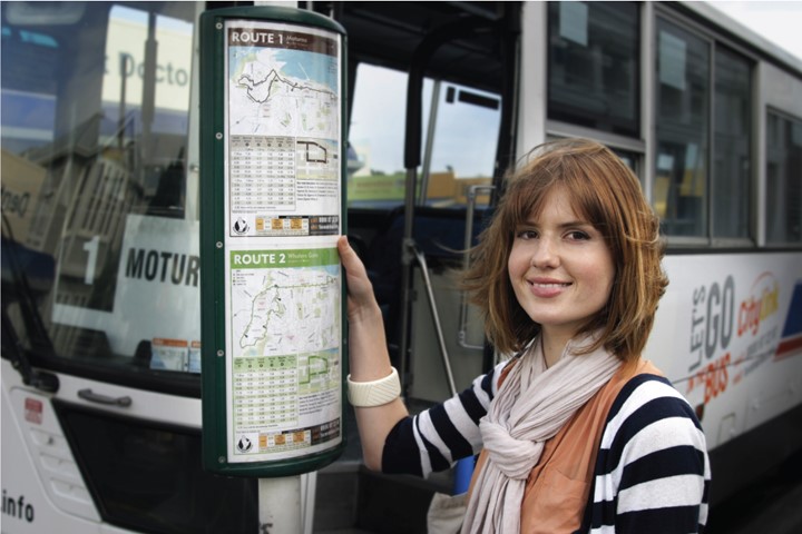 Woman looking at bus timetable