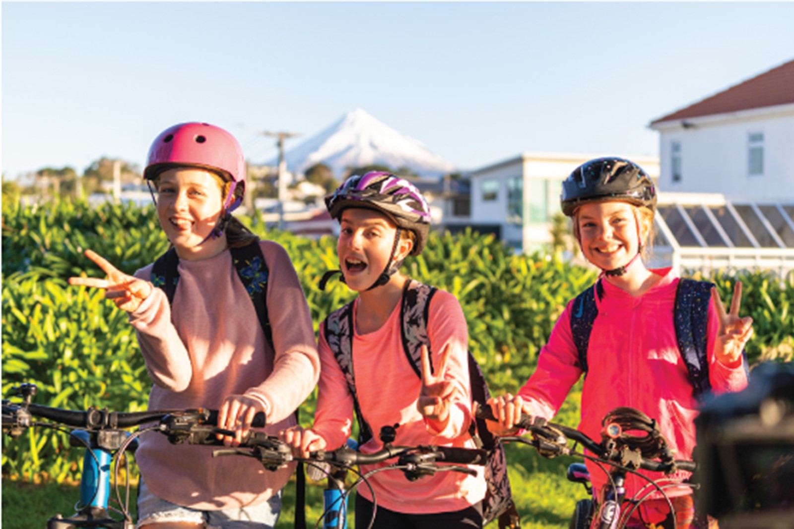 Three girls biking to school