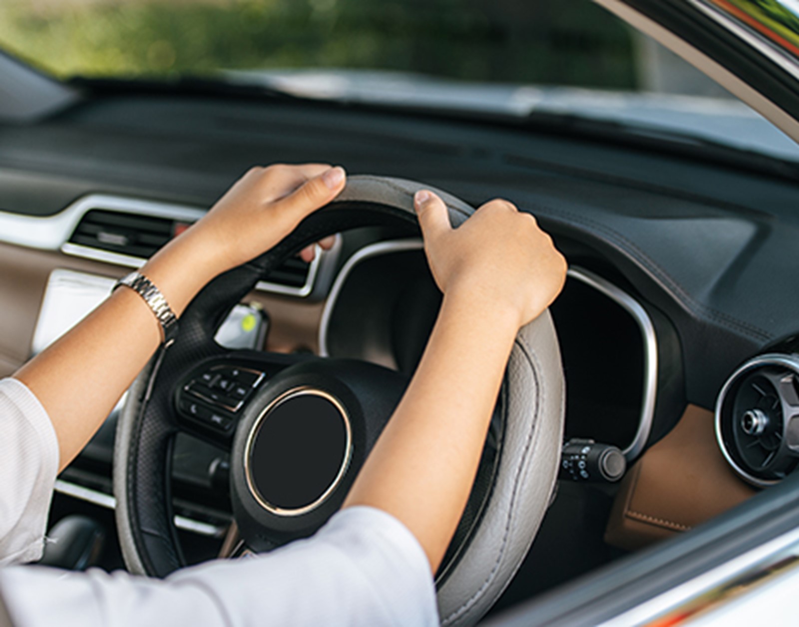 Woman's hands on steering wheel
